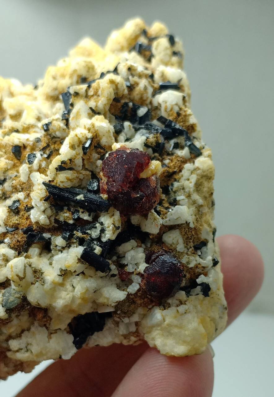 An amazing specimen of black Tourmaline crystals and etched spessartine crystals on matrix of Albite 248 grams