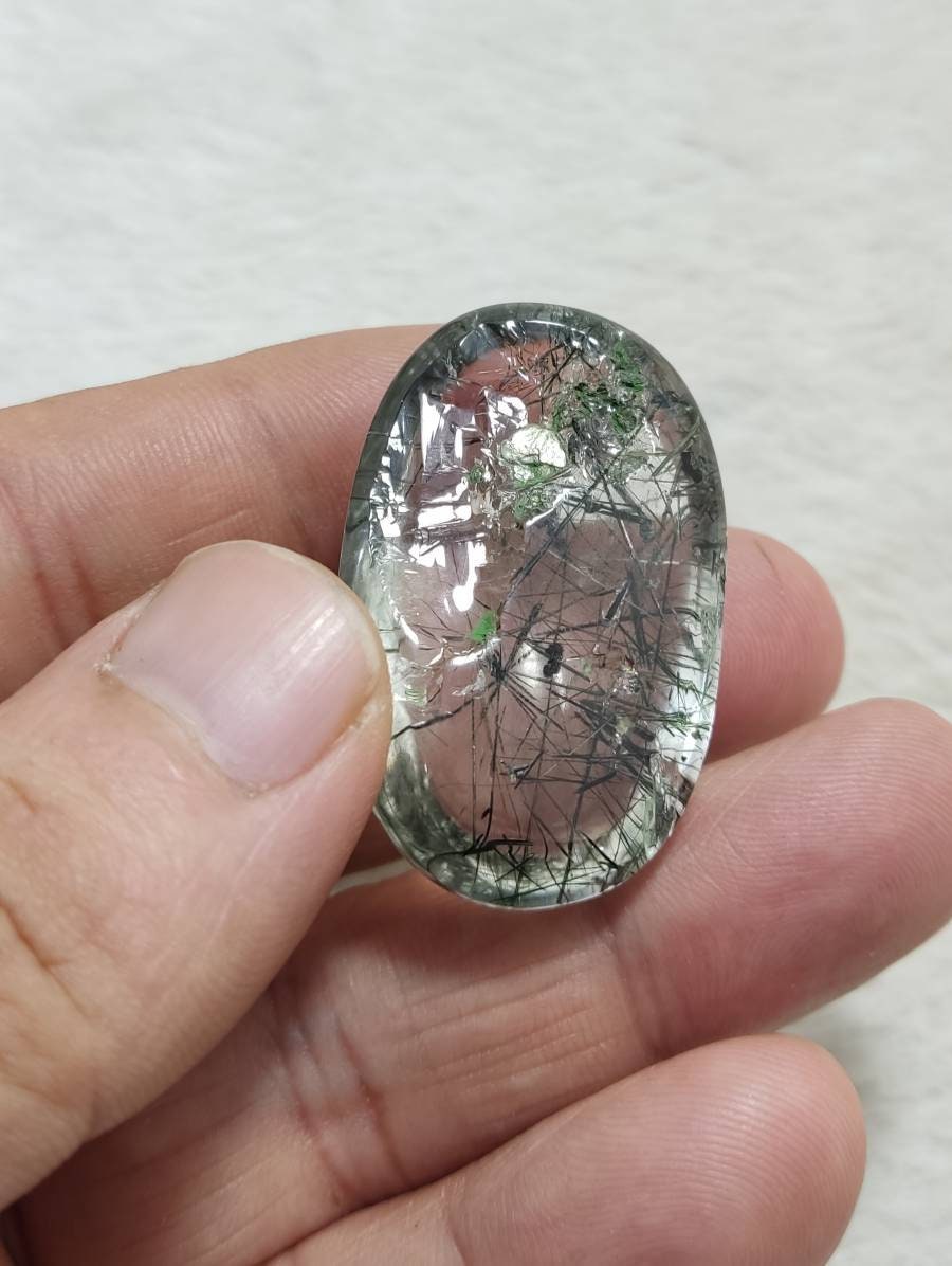 An amazing cabochon of byss-olite included quartz 128 carats