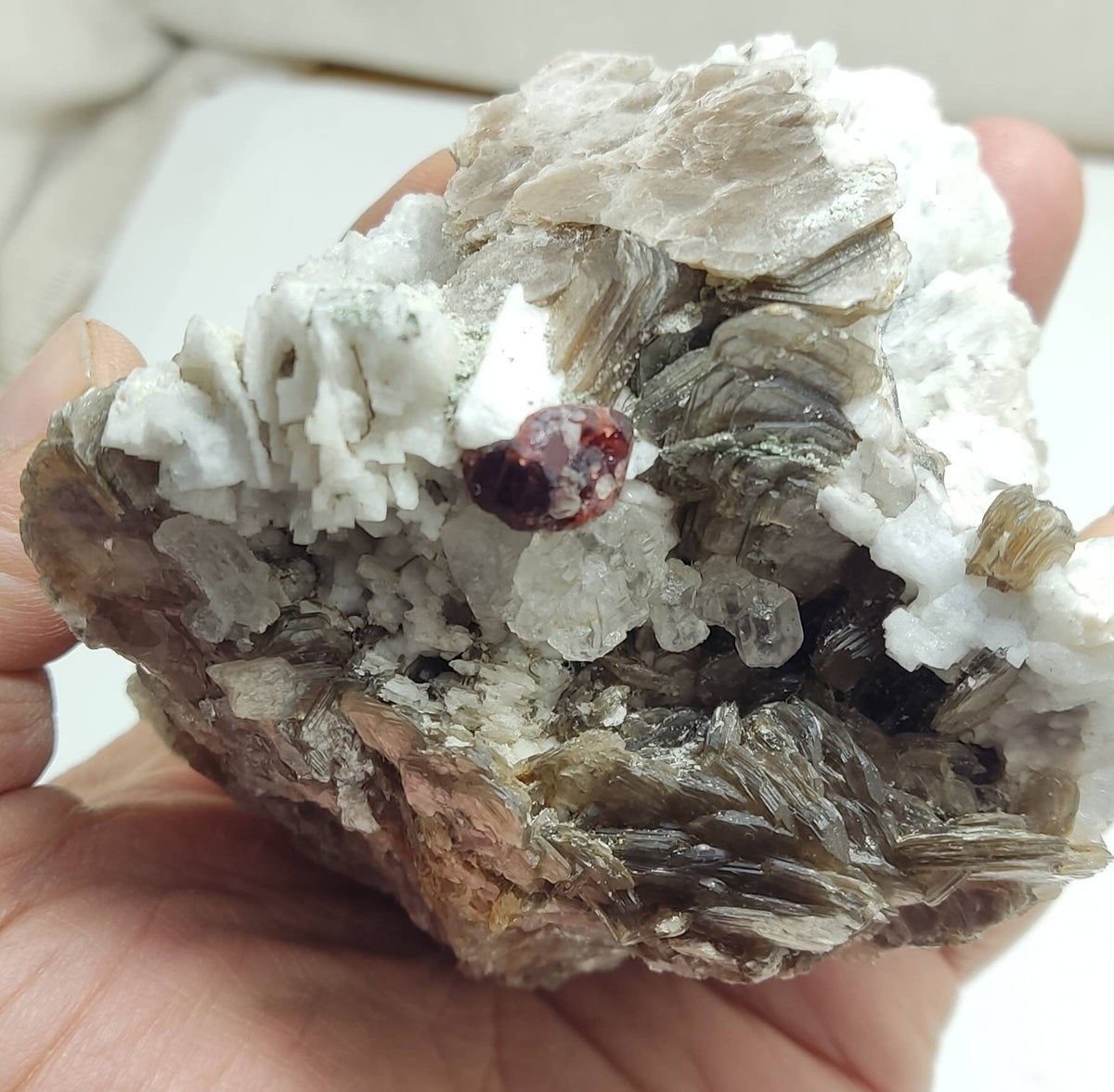 Natural spessartine garnet embedded in muscovite, with albite and quartz 544 grams
