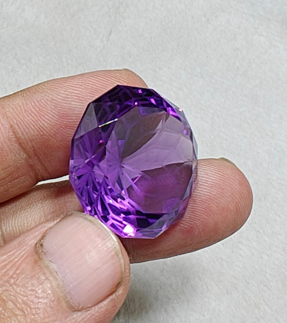 An amazing faceted fancy cut amethyst gemstone 77 carats