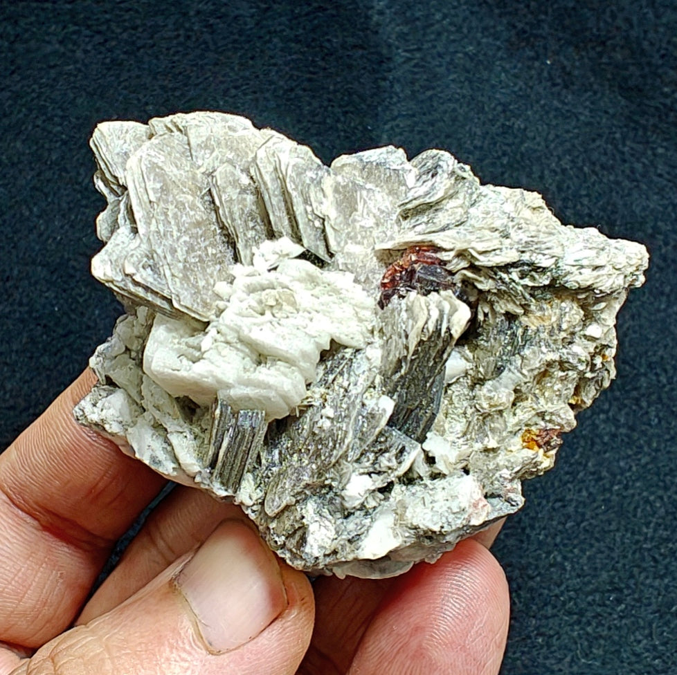 Natural spessartine garnet embedded in muscovite, with albite 150 grams