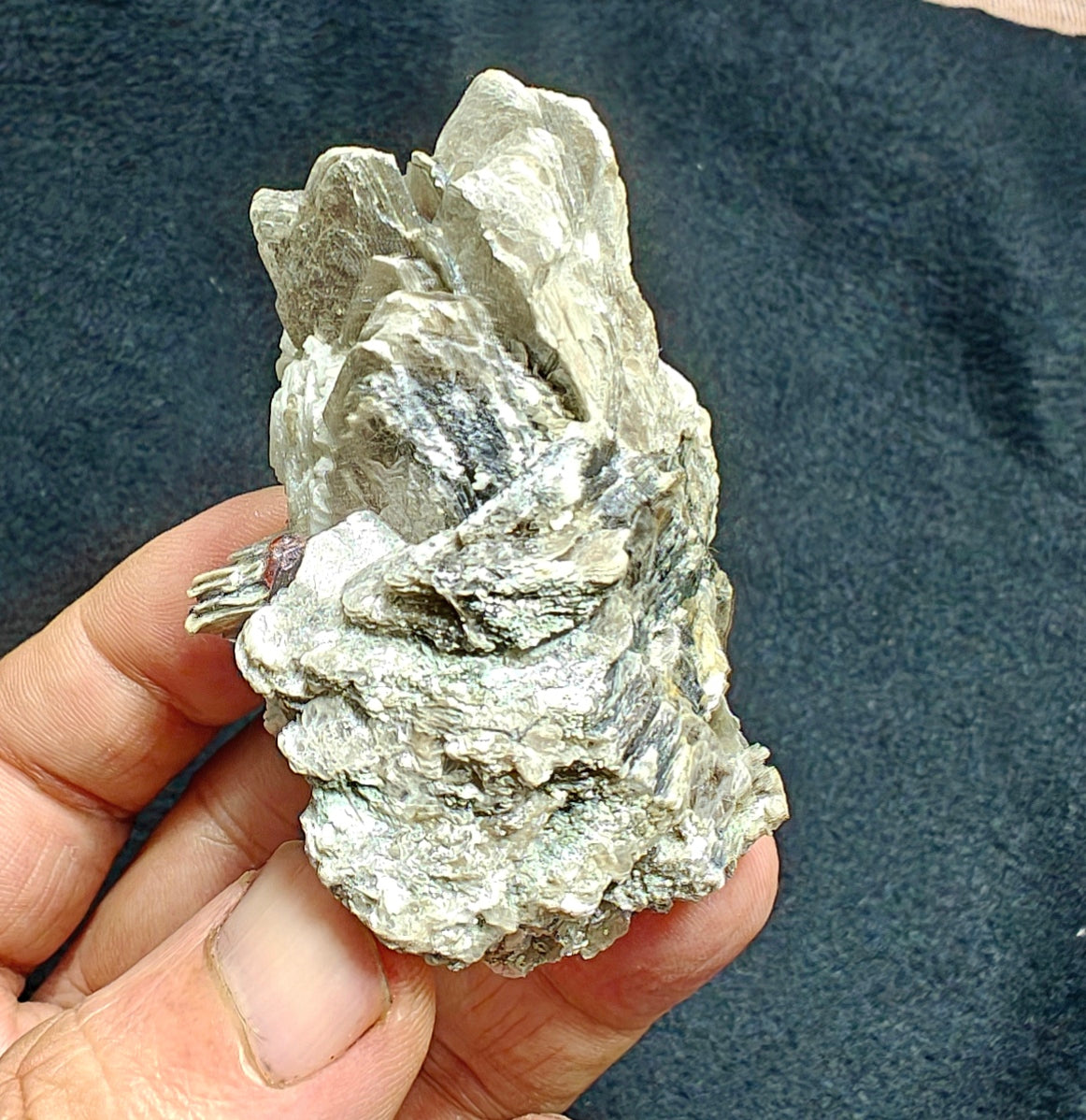 Natural spessartine garnet embedded in muscovite, with albite 150 grams