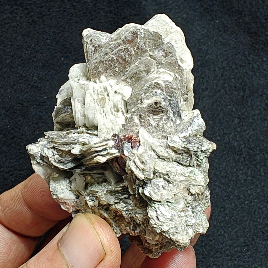 Natural spessartine garnet embedded in muscovite, with albite 150 grams