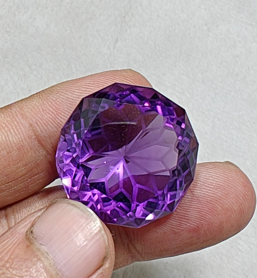 An amazing faceted fancy cut amethyst gemstone 77 carats