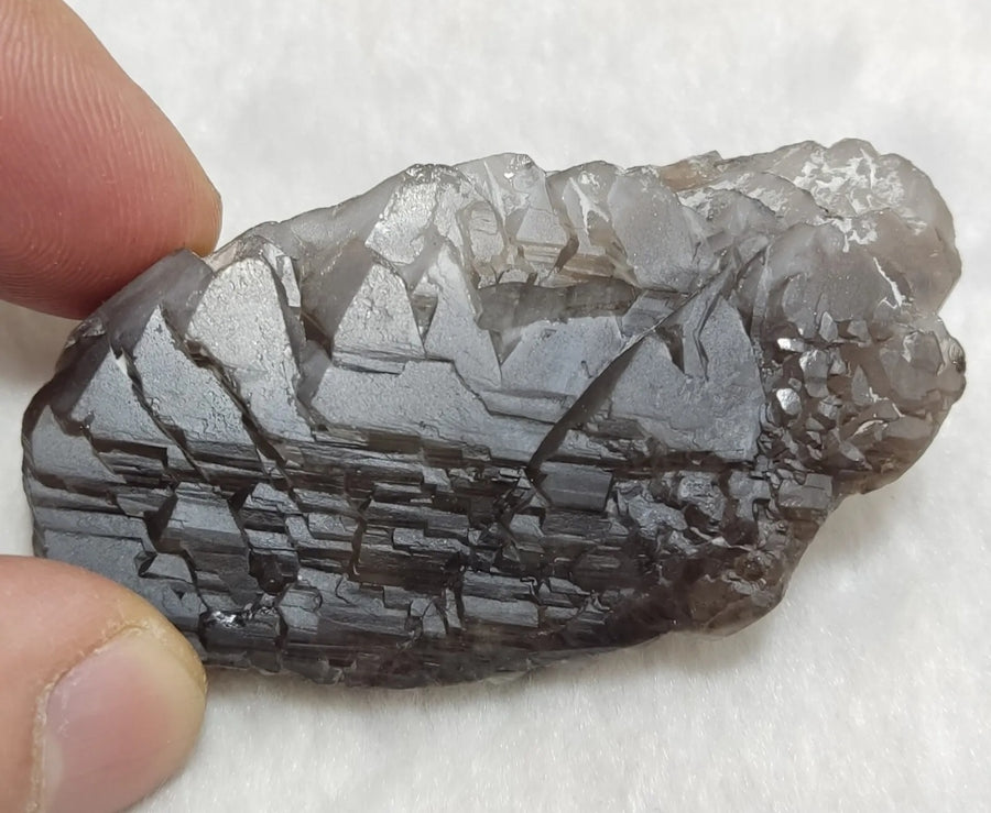Close-up of the stepped skeletal patterns on natural smoky quartz