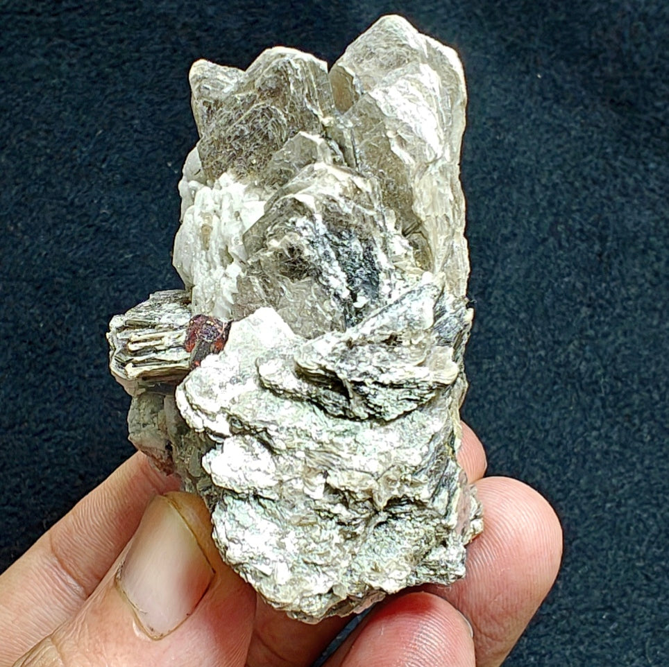 Natural spessartine garnet embedded in muscovite, with albite 150 grams