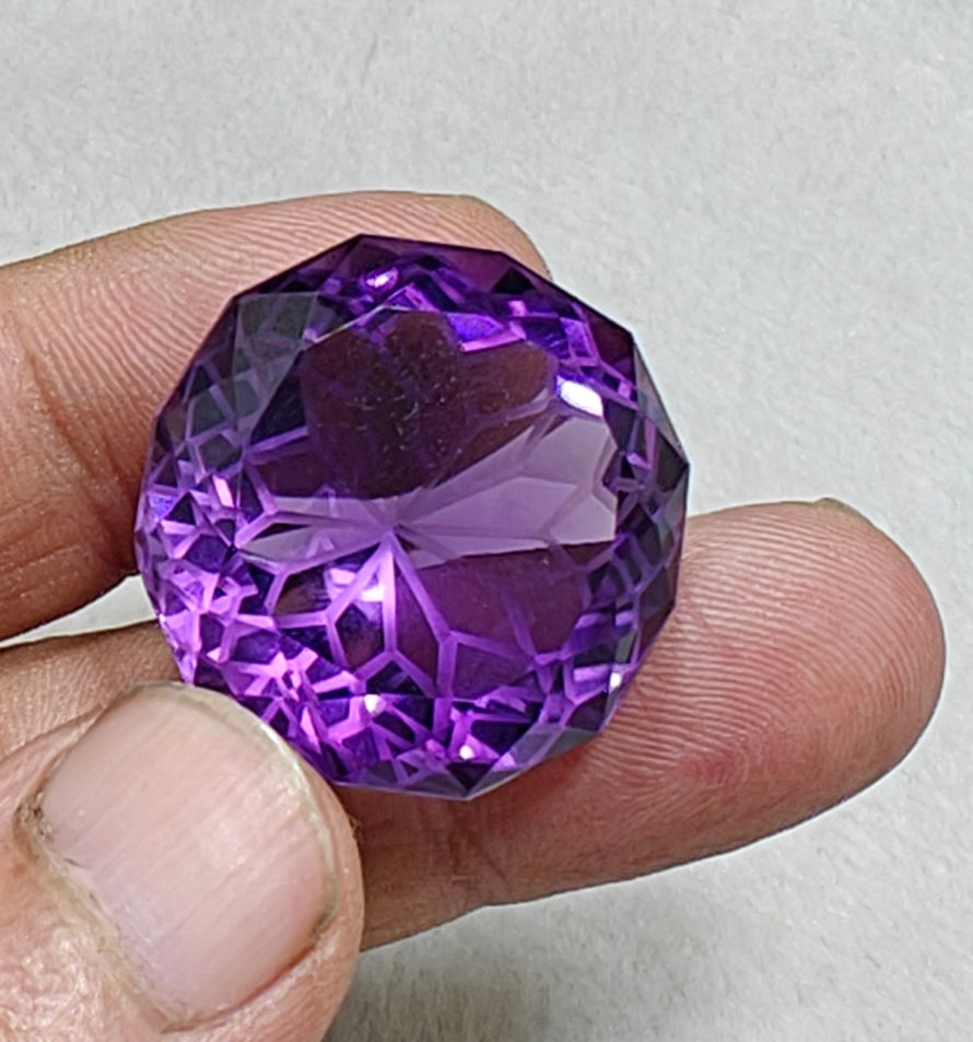 An amazing faceted fancy cut amethyst gemstone 77 carats