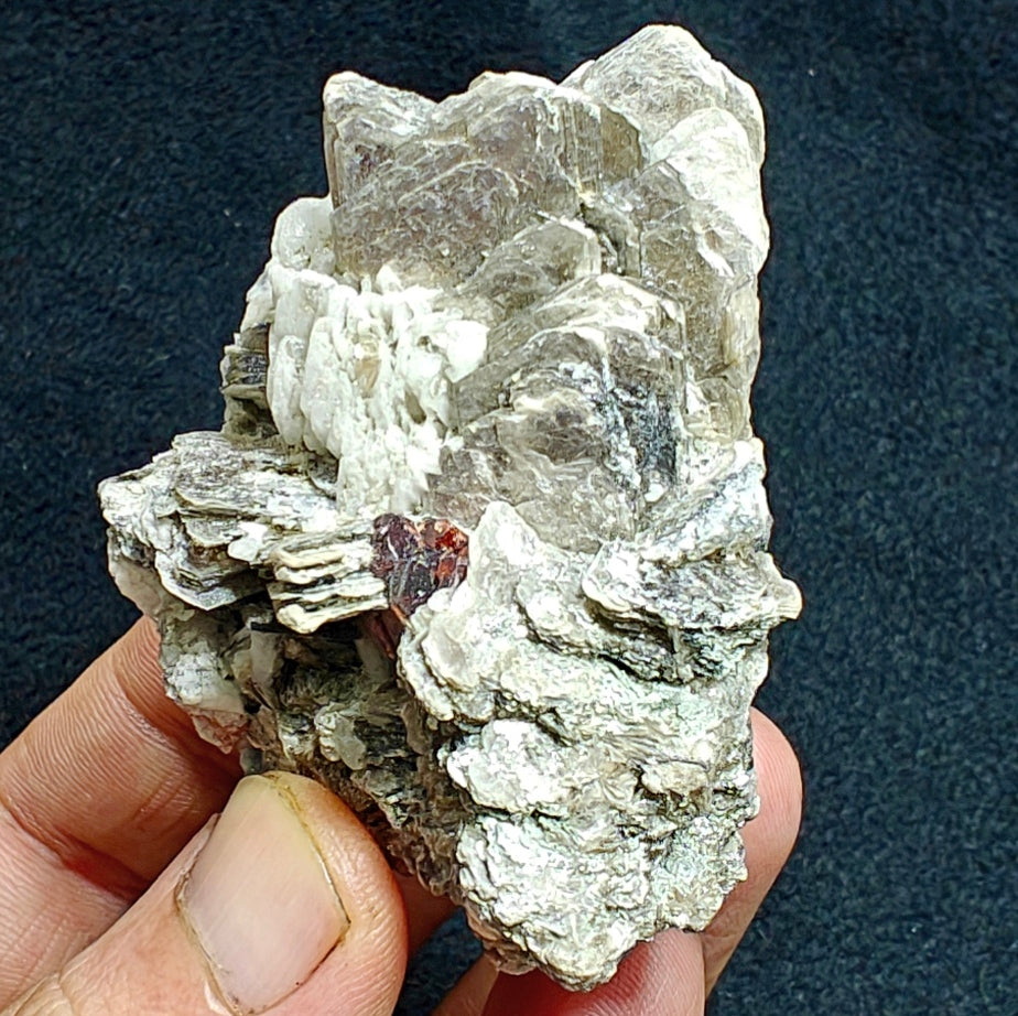 Natural spessartine garnet embedded in muscovite, with albite 150 grams