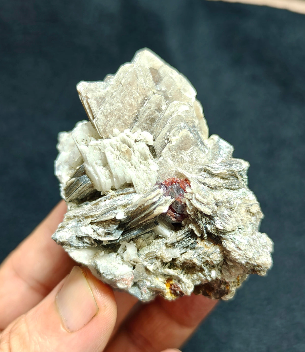 Natural spessartine garnet embedded in muscovite, with albite 150 grams