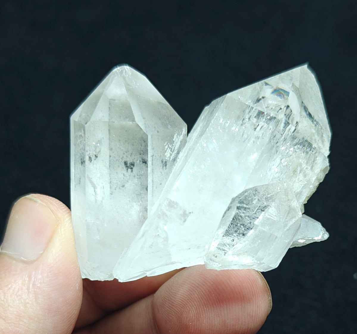 An amazing specimen of twin terminated Quartz Crystals with another small terminated Crystal attached 76 grams