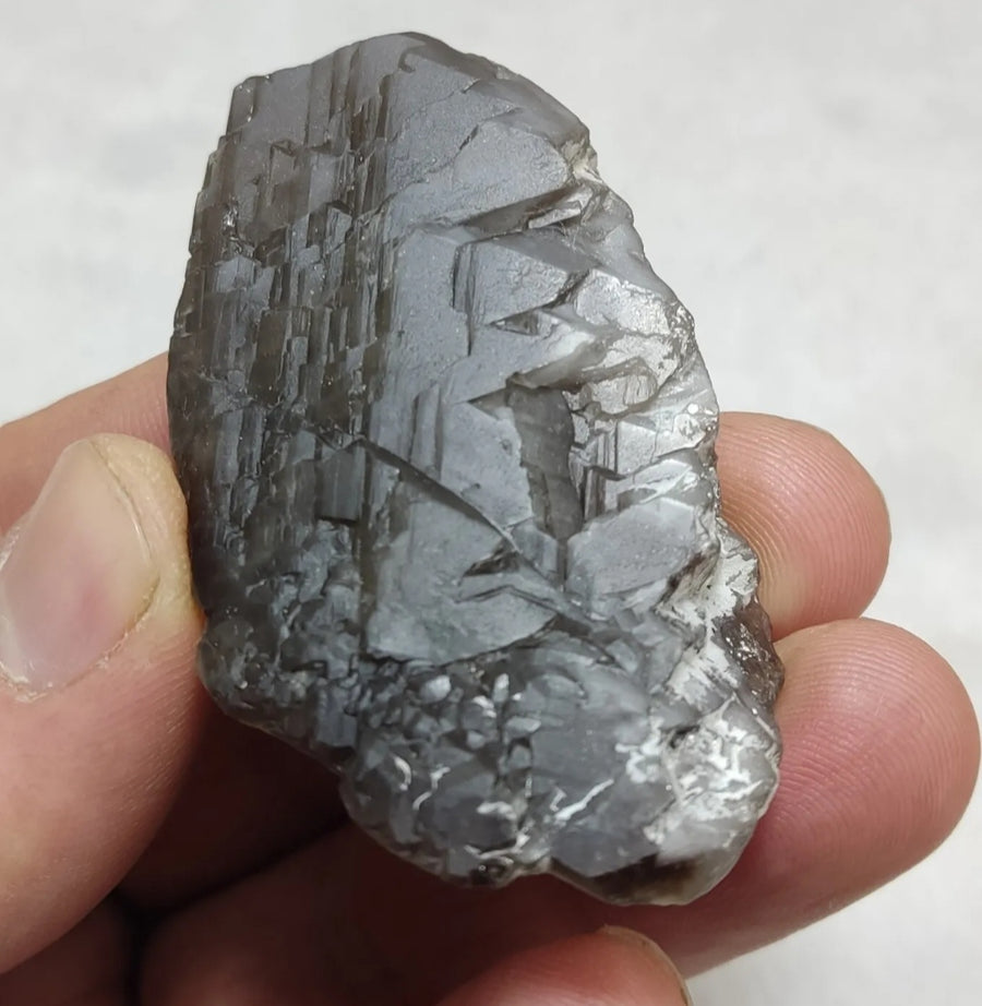 Side view of a natural smoky quartz specimen showing its crystal structure