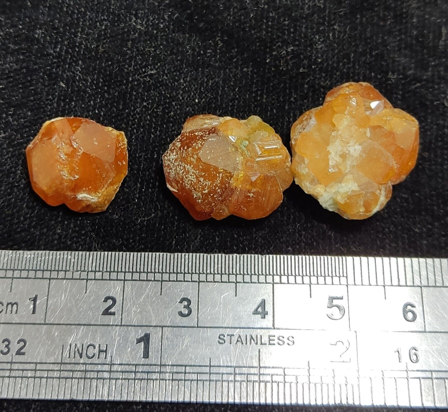 A selection of three garnet variety hessonite crystals 14.8 grams