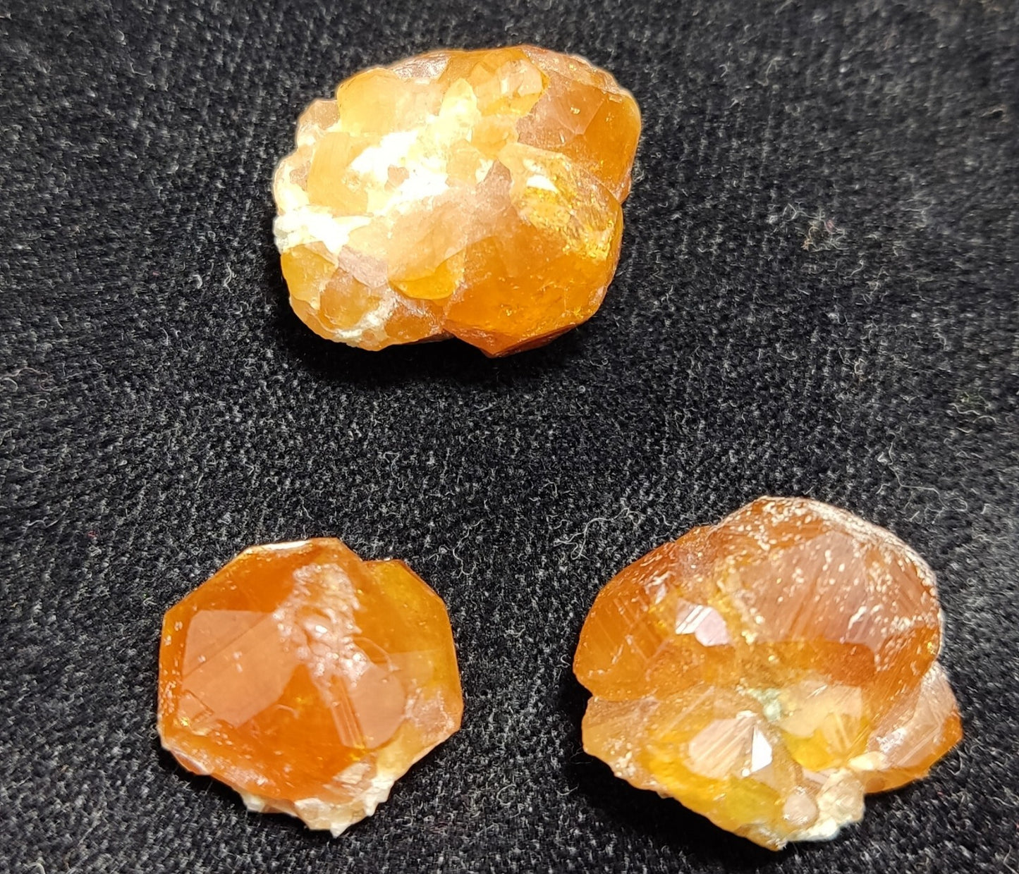A selection of three garnet variety hessonite crystals 14.8 grams