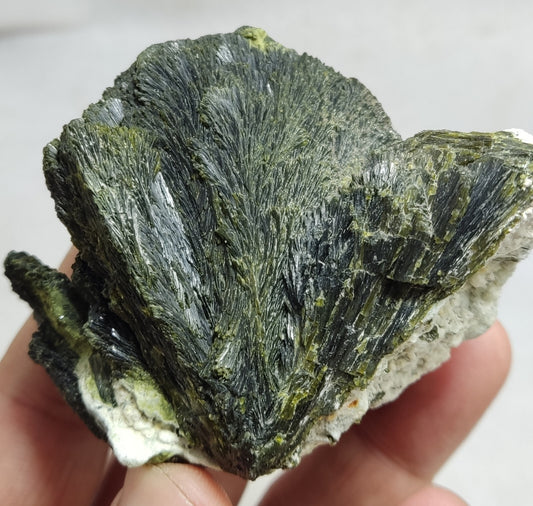 An aesthetic specimen of epidote crystal spray type on matrix 182 grams