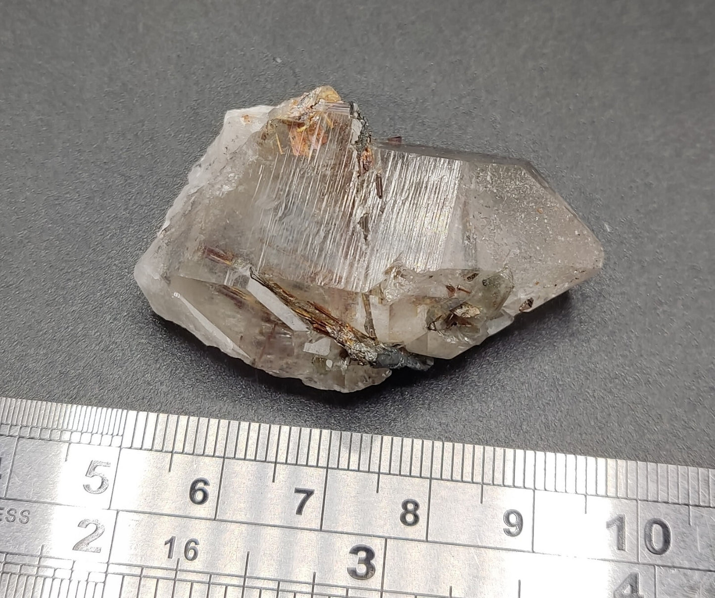 An aesthetic specimen of quartz with hematite and rutile inclusions 28 grams