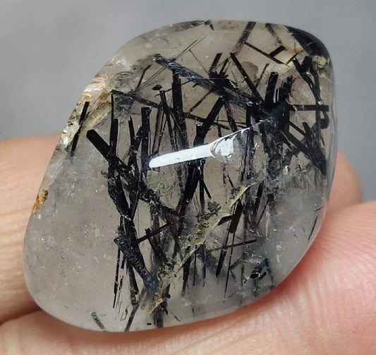 Rutiles/aegirine/ Unconfirmed quartz polished tumble 75 carats