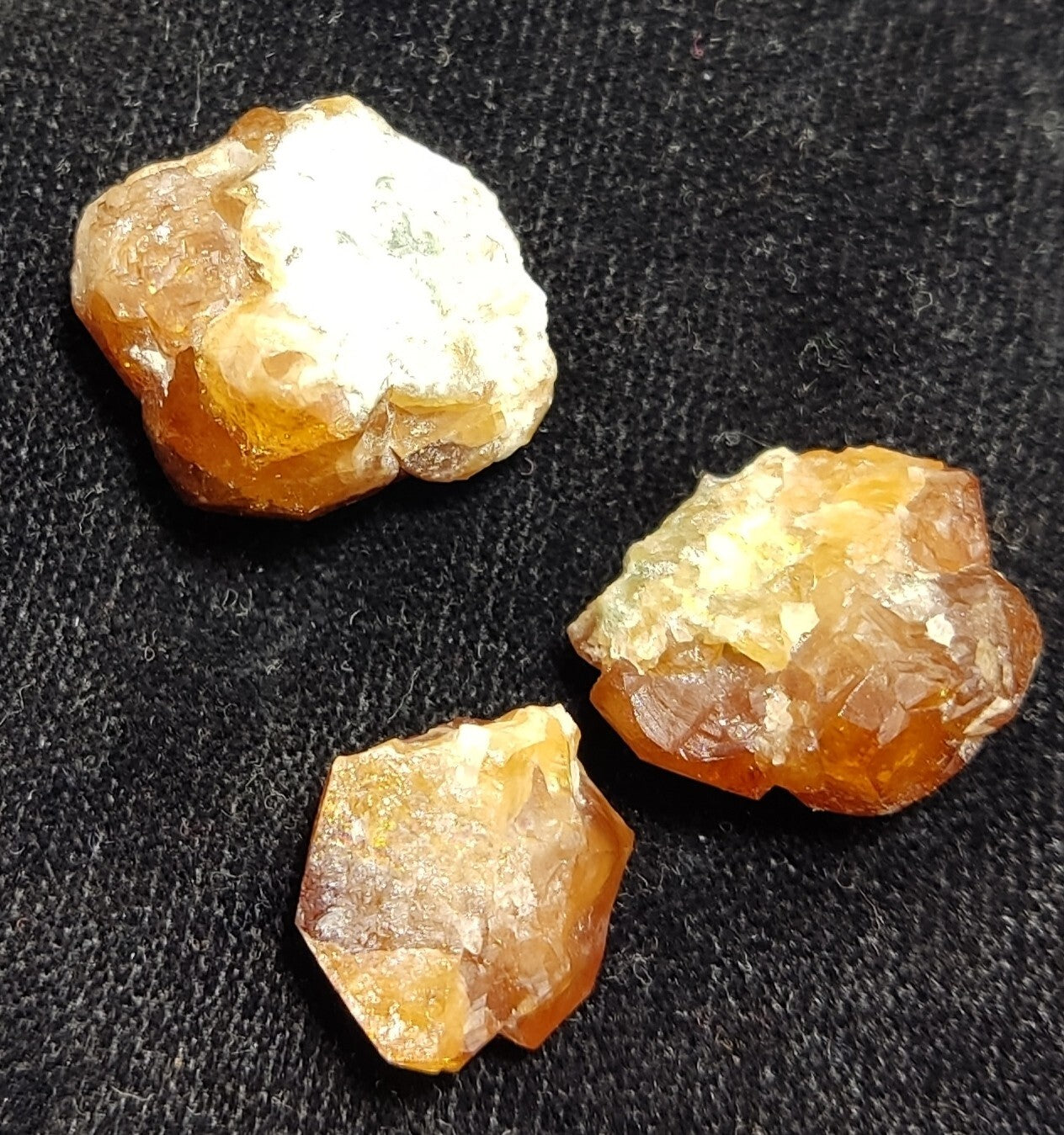A selection of three garnet variety hessonite crystals 14.8 grams