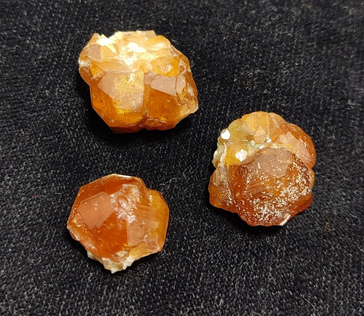 A selection of three garnet variety hessonite crystals 14.8 grams