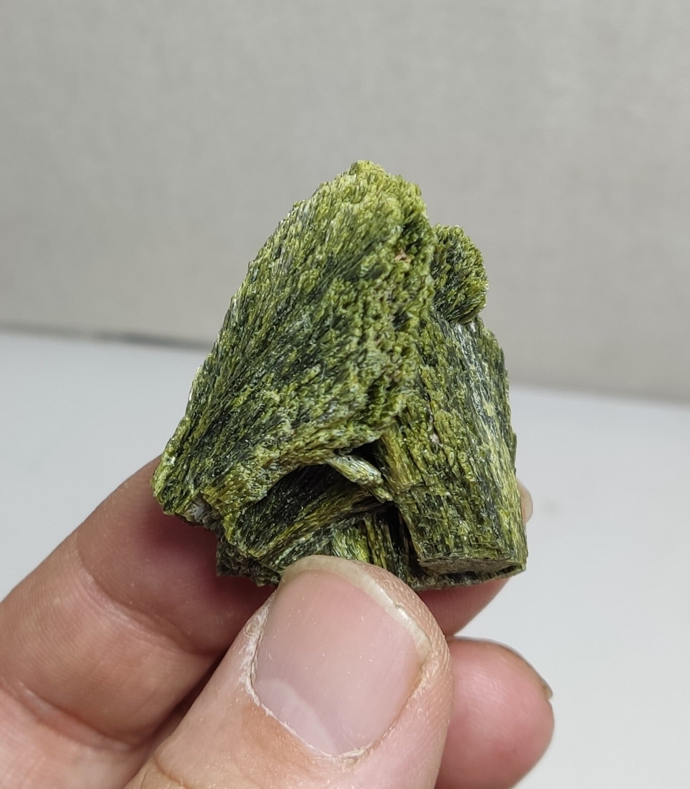 An aesthetic specimen of epidote crystal spray type 35 grams