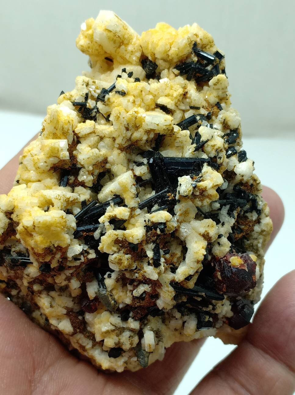 An amazing specimen of black Tourmaline crystals and etched spessartine crystals on matrix of Albite 248 grams