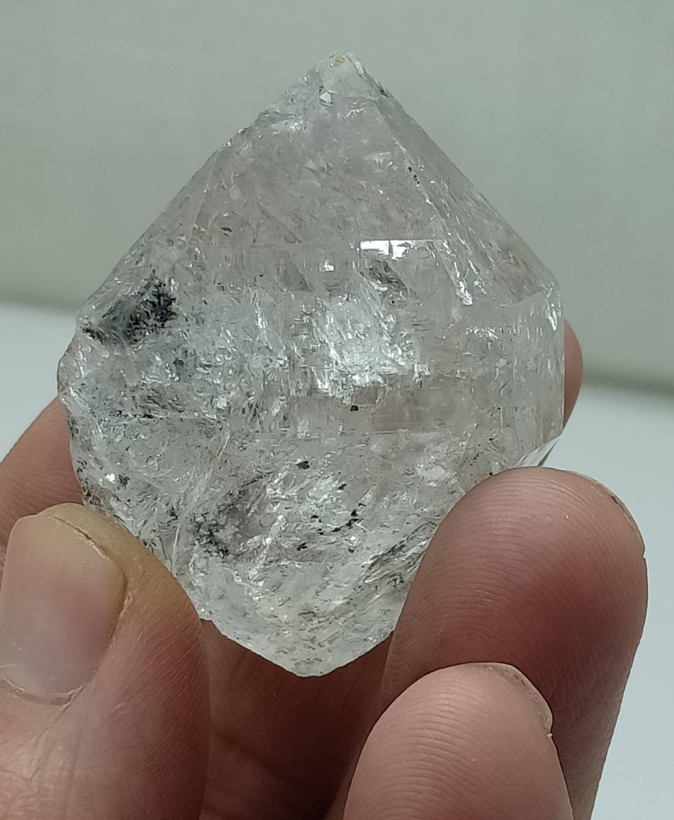 An amazing double terminated diamond like quartz crystal with carbon inclusions 57 grams