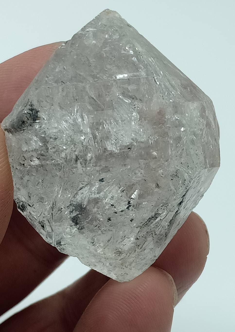 An amazing double terminated diamond like quartz crystal with carbon inclusions 57 grams