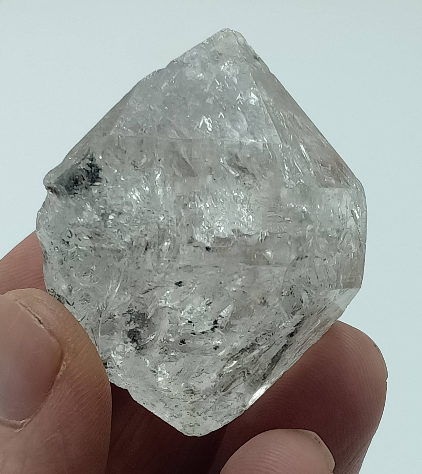 An amazing double terminated diamond like quartz crystal with carbon inclusions 57 grams