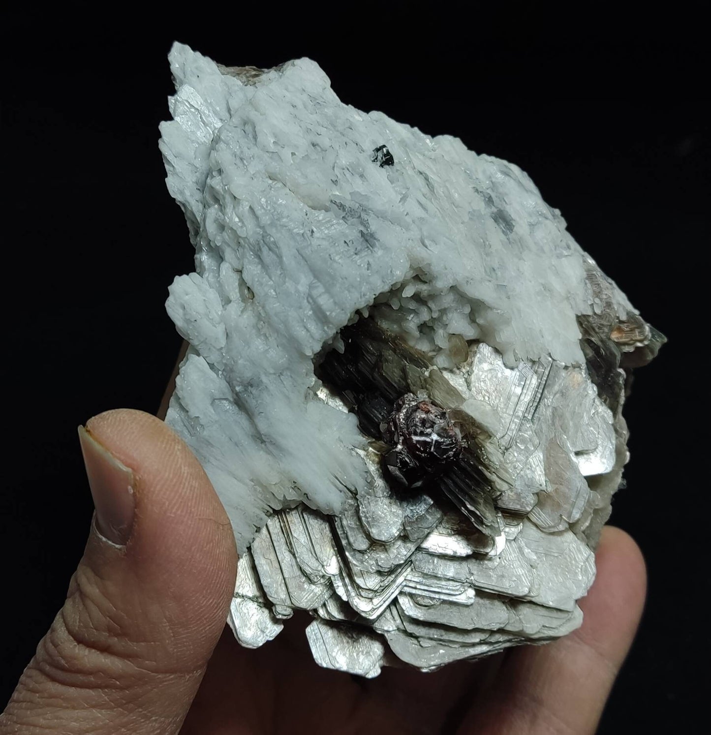 An amazing aesthetic specimen of spessartine garnet embedded in muscovite and albite 433 grams