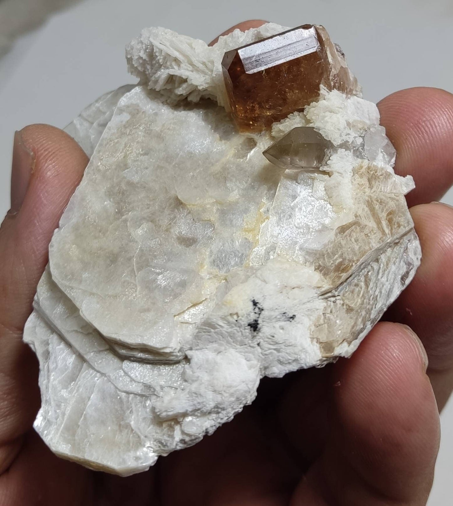 An amazing Specimen of terminated peach color Topaz crystal embedded in muscovite 48 grams