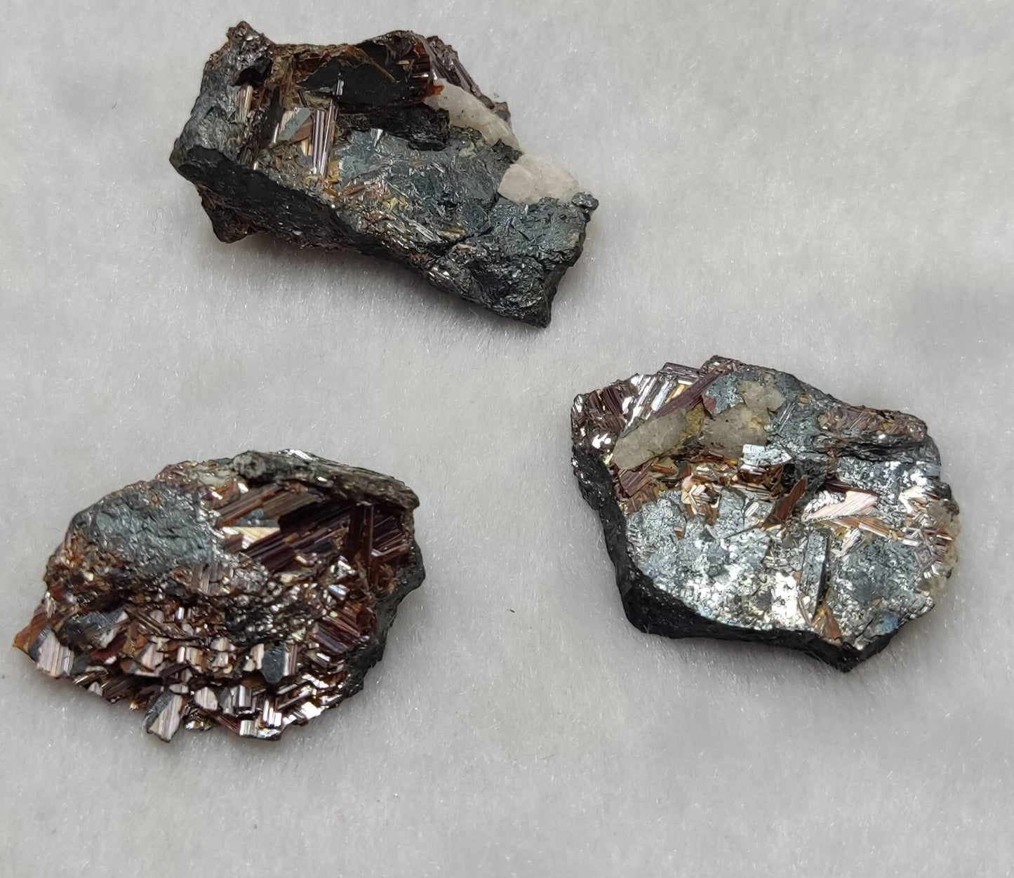 An amazing lot of 3 specimen of rutile variety saginite on hematite