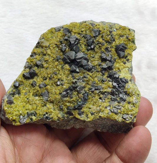 An aesthetic specimen of magnetite with epidotes 329 grams
