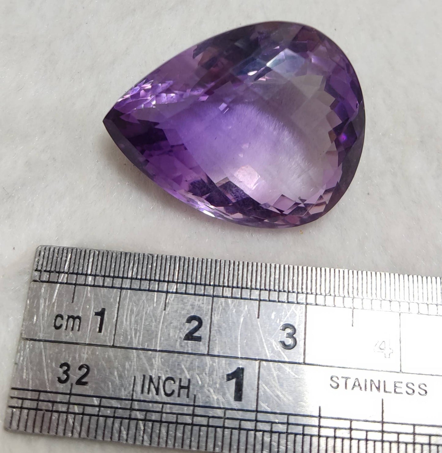 Tear drop cut faceted amethyst gemstone 64 carats